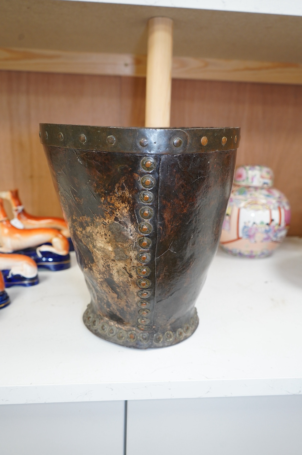 A Georgian mounted leather fire bucket (waste paper bin), 27cm high. Condition - fair